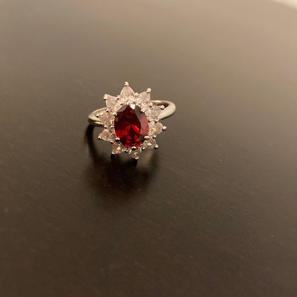 Artificial ruby and CZ starburst halo ring.